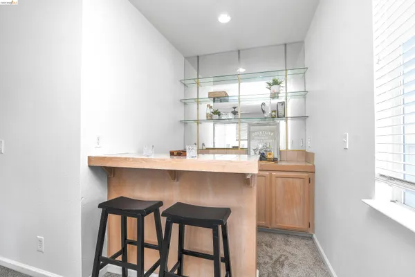 a kitchen with stainless steel appliances a table and chairs in it