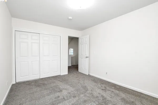 an empty room with closet area