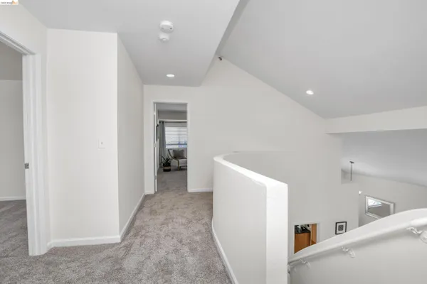 a view of hallway with stairs and wooden floor
