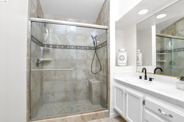 a bathroom with a shower and a sink