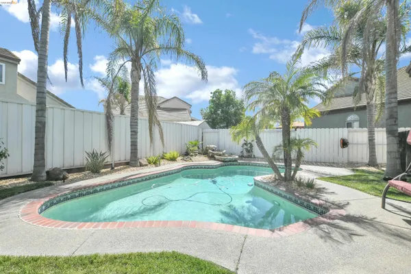 a backyard of a house with table and chairs