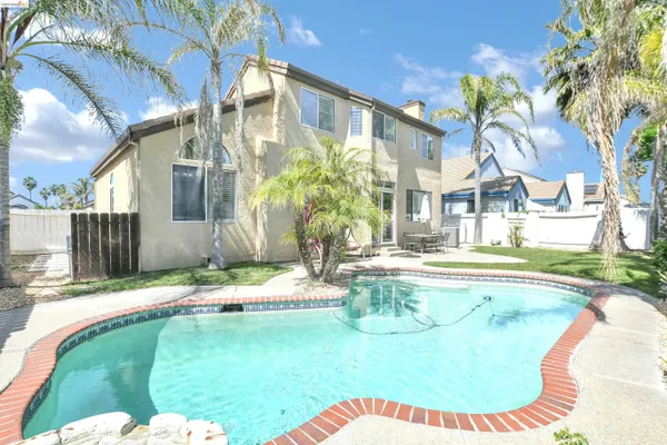 a swimming pool with outdoor seating and yard