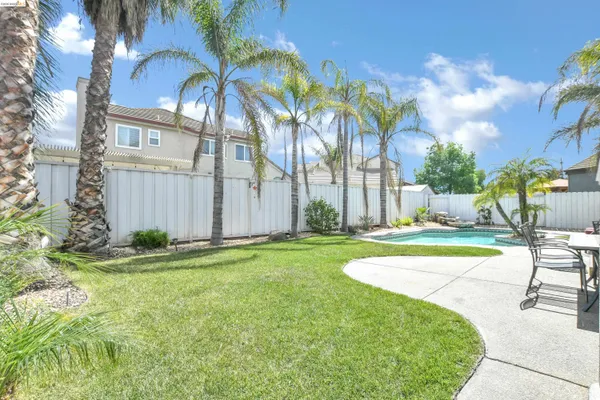 a view of a backyard with swimming pool