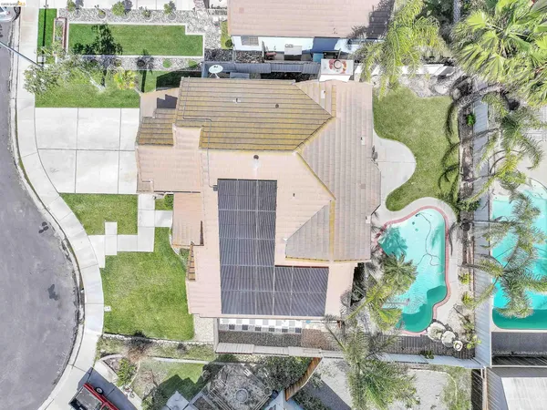 an aerial view of a house with a yard and potted plants