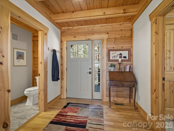 a bedroom with a large bed and wooden floor