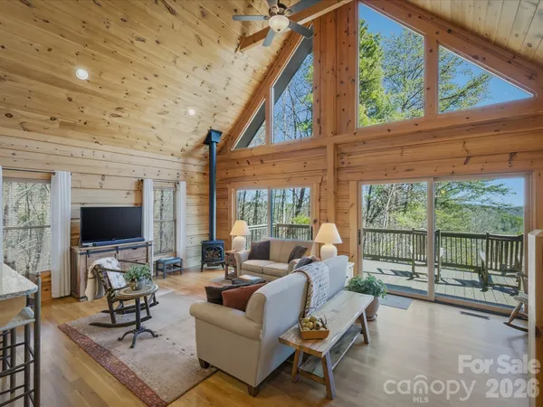 a view of a balcony with wooden floor and outdoor seating