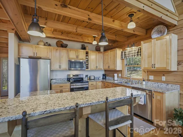 a living room with furniture a flat screen tv and a floor to ceiling window
