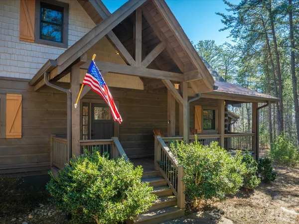 a view of house with backyard and deck