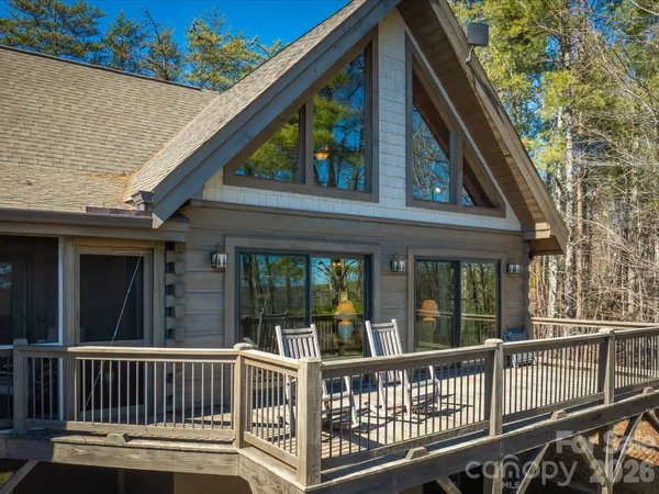 a view of a lush green forest with trees and some houses