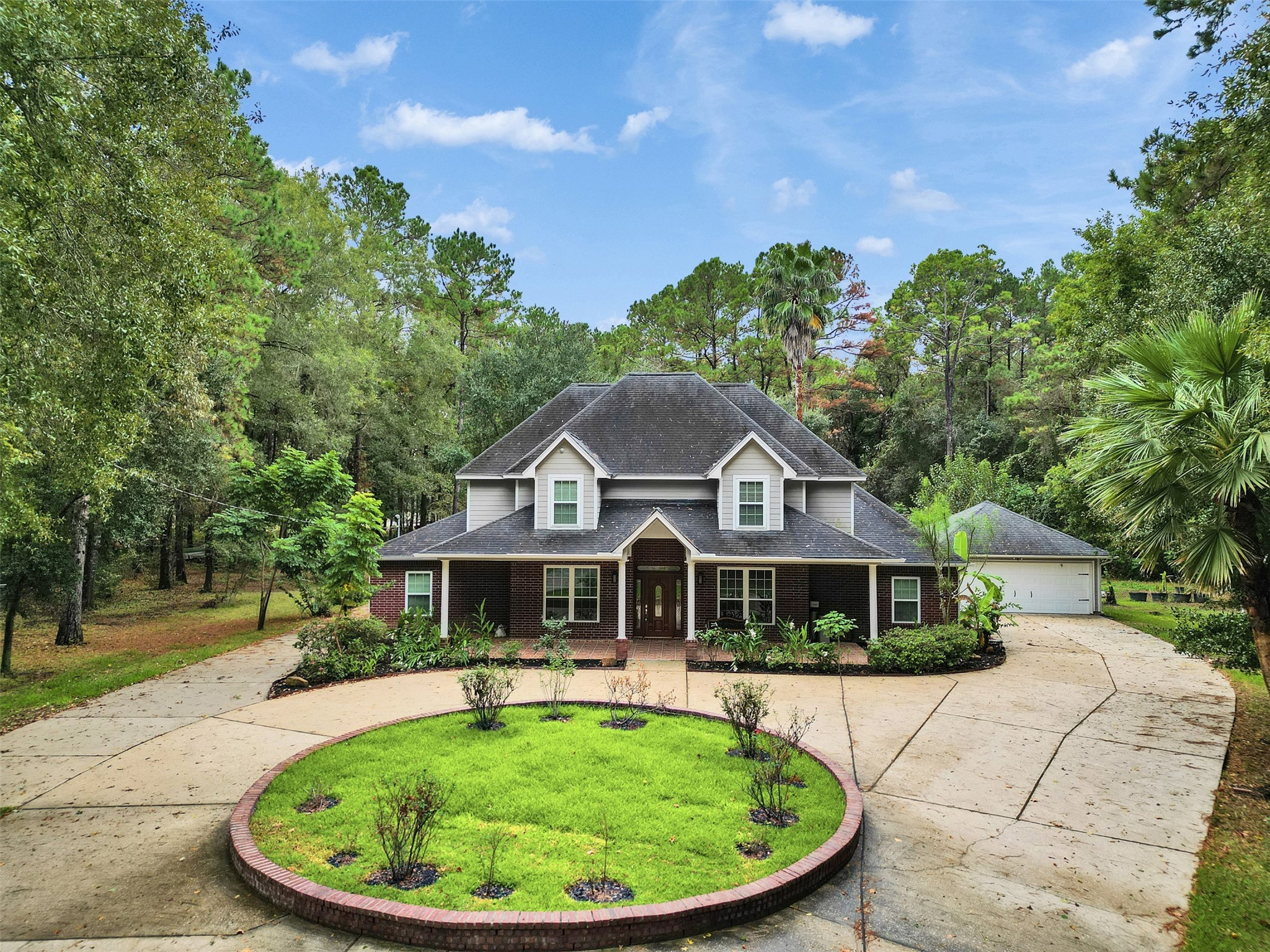 a front view of a house with a garden
