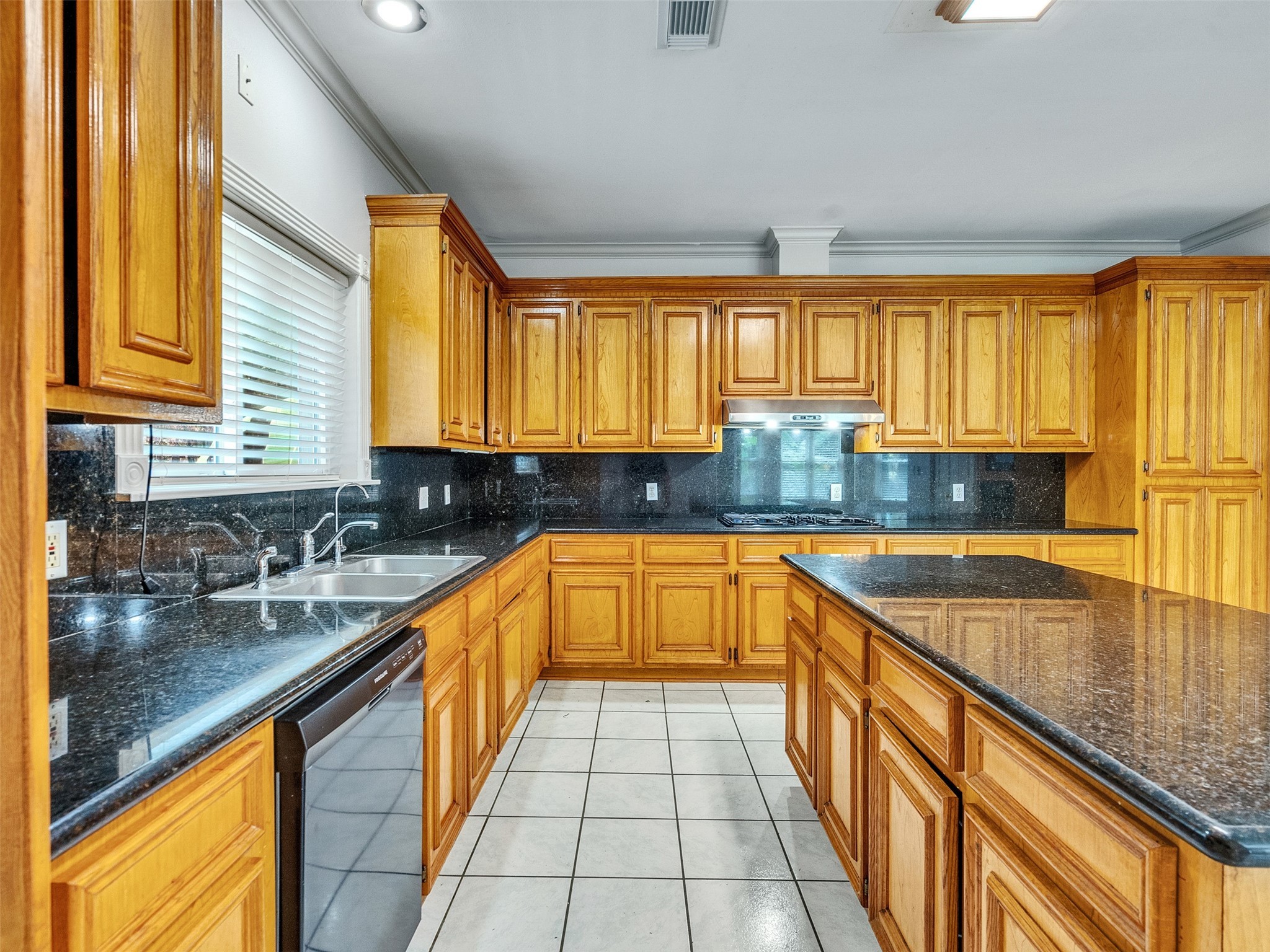 22872 Mersey Court Porter, TX 77365 - Photo 18 of 48 a kitchen with a sink a counter top space and stainless steel appliances