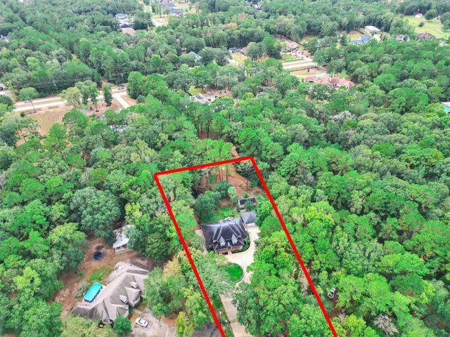 an aerial view of residential houses with outdoor space and street view