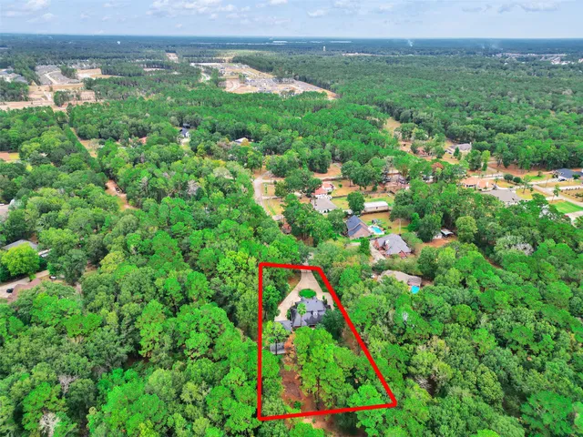 a view of a house with a yard and potted plants
