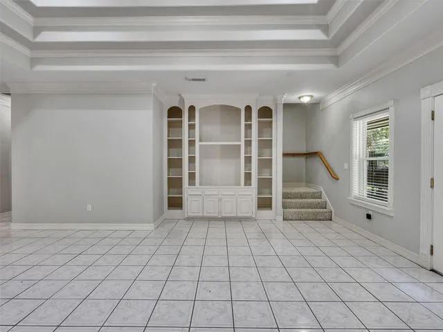 a view of an empty room with stairs