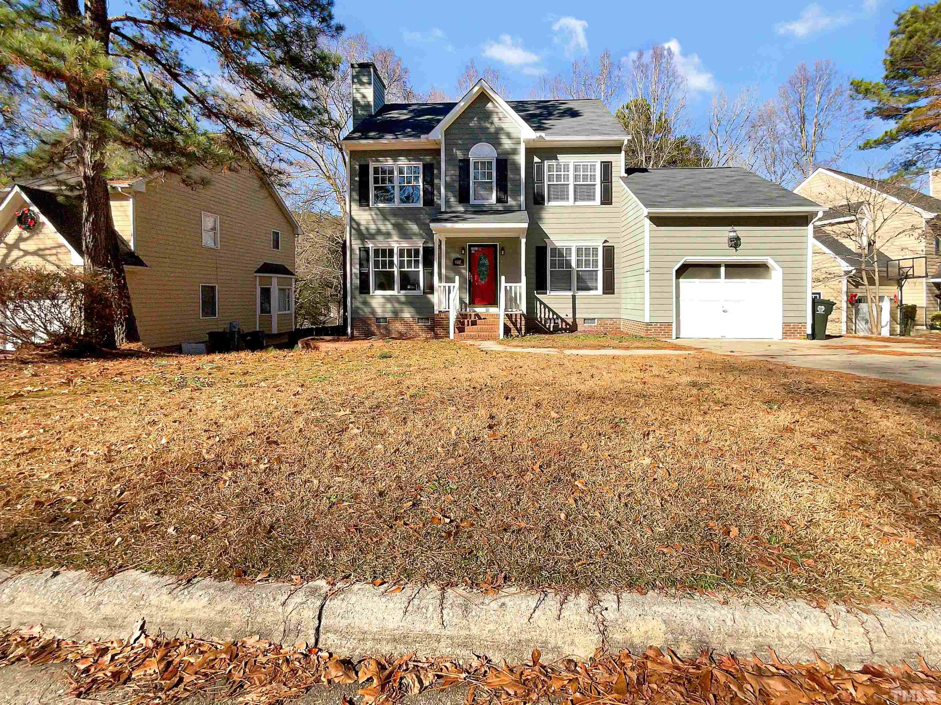 6017 Tarleton Court Raleigh, NC 27616 - Photo 1 of 26 a front view of a house with a yard covered with snow in front of house