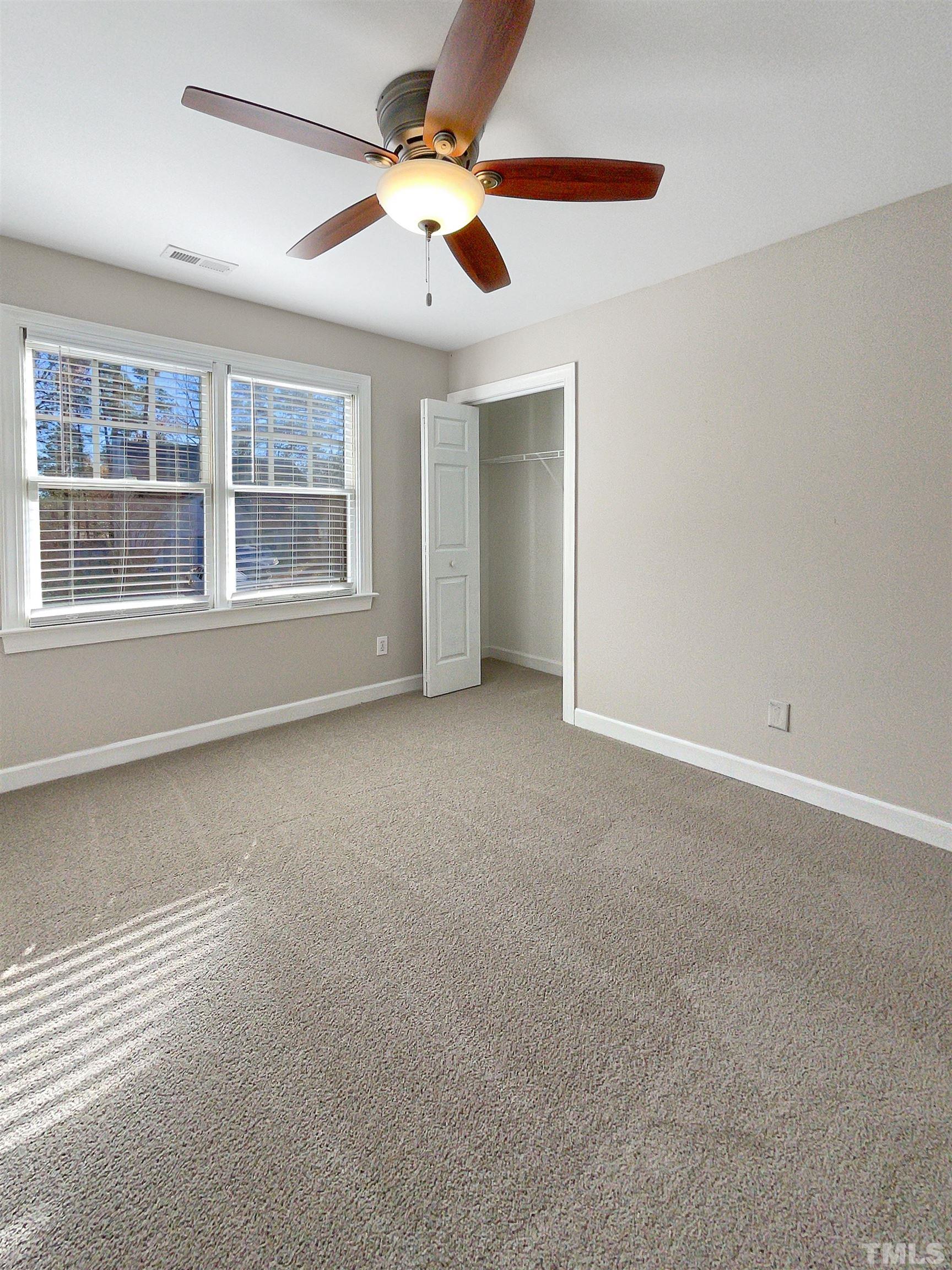 6017 Tarleton Court Raleigh, NC 27616 - Photo 14 of 26 an empty room with windows and fan