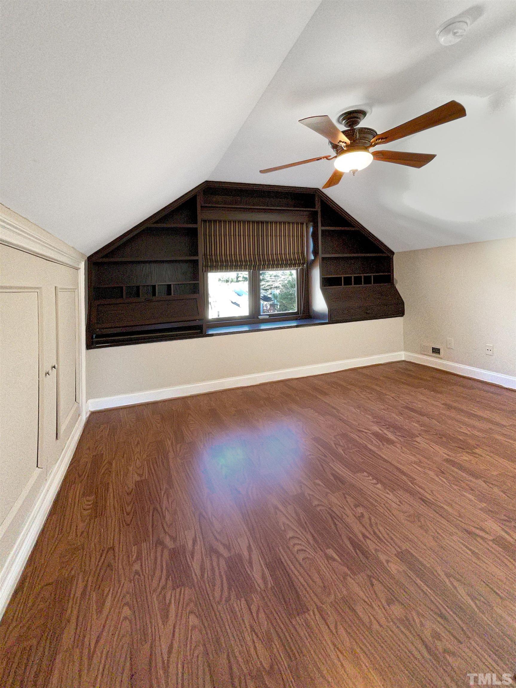 6017 Tarleton Court Raleigh, NC 27616 - Photo 19 of 26 a view of an empty room with wooden floor and a ceiling fan