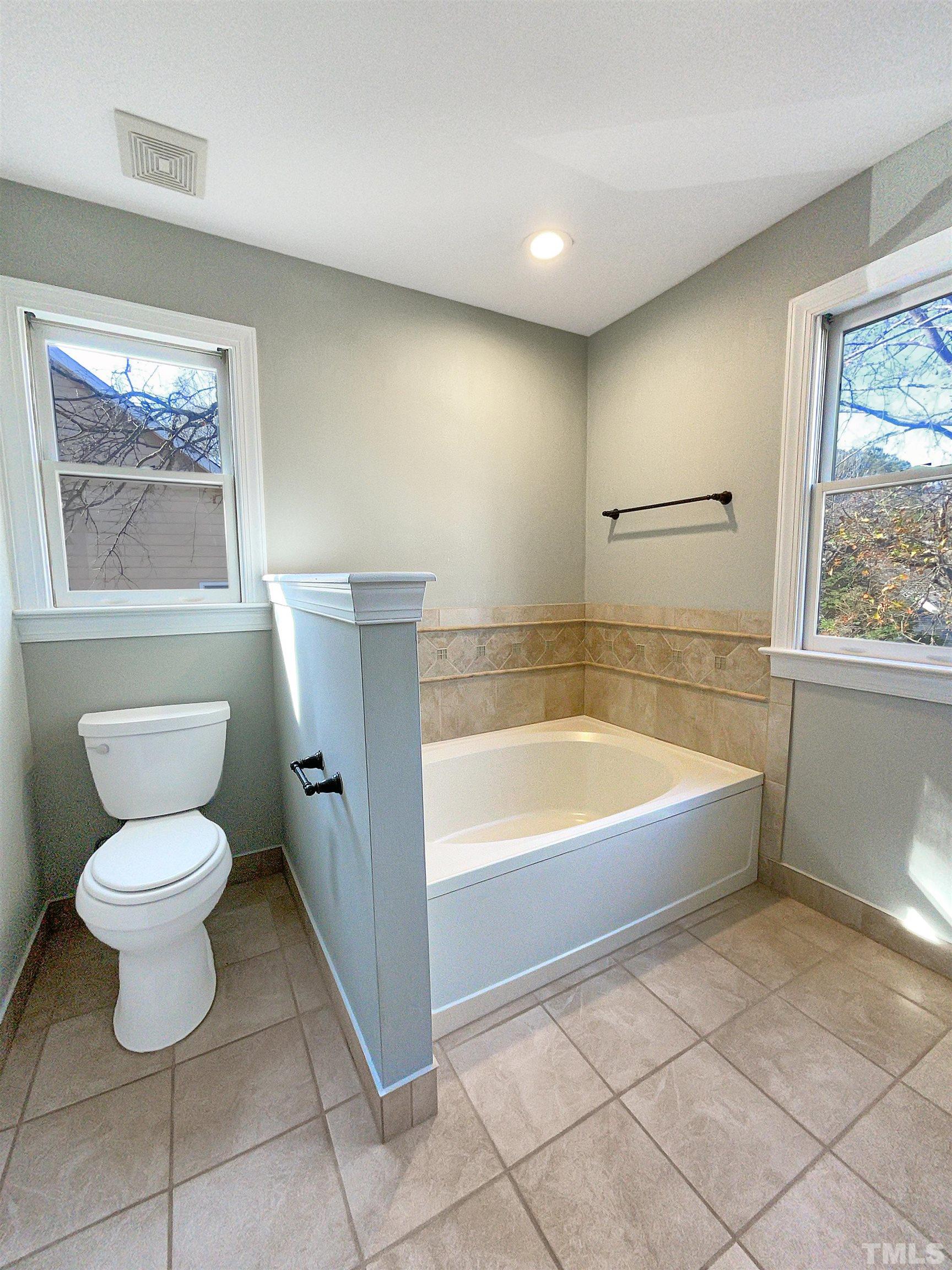 6017 Tarleton Court Raleigh, NC 27616 - Photo 4 of 26 a bathroom with a toilet sink and bathtub