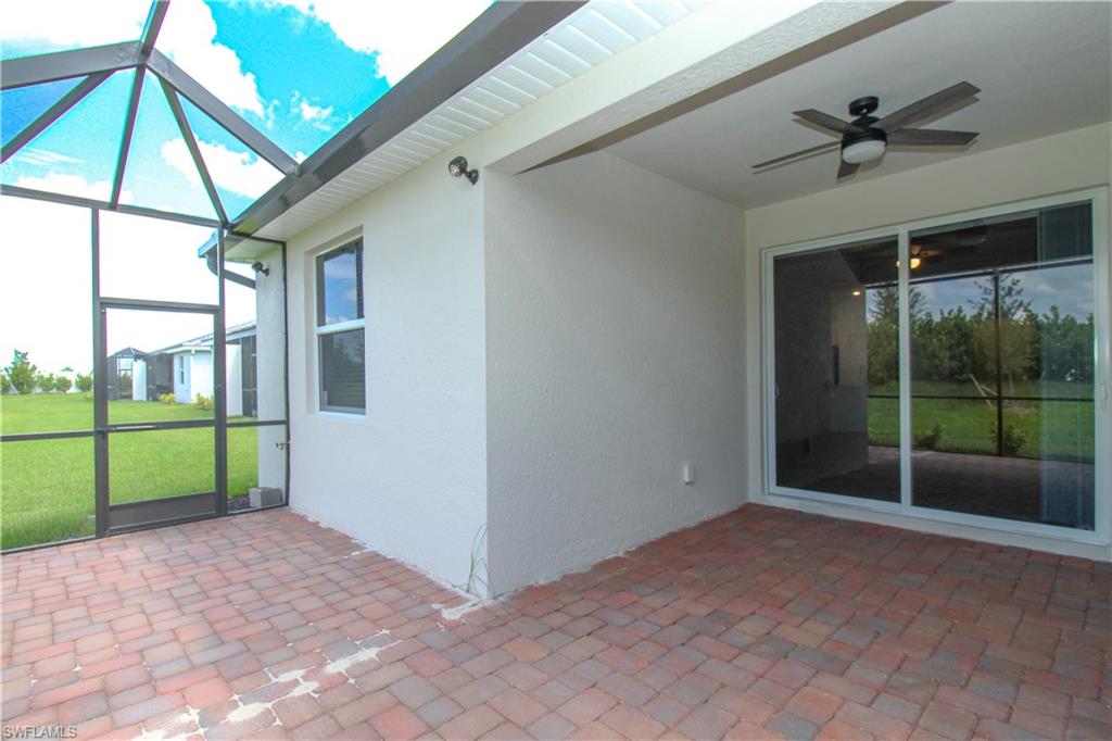 2156 Dragonfruit Way Naples, FL 34120 - Photo 17 of 50 Unfurnished sunroom featuring ceiling fan