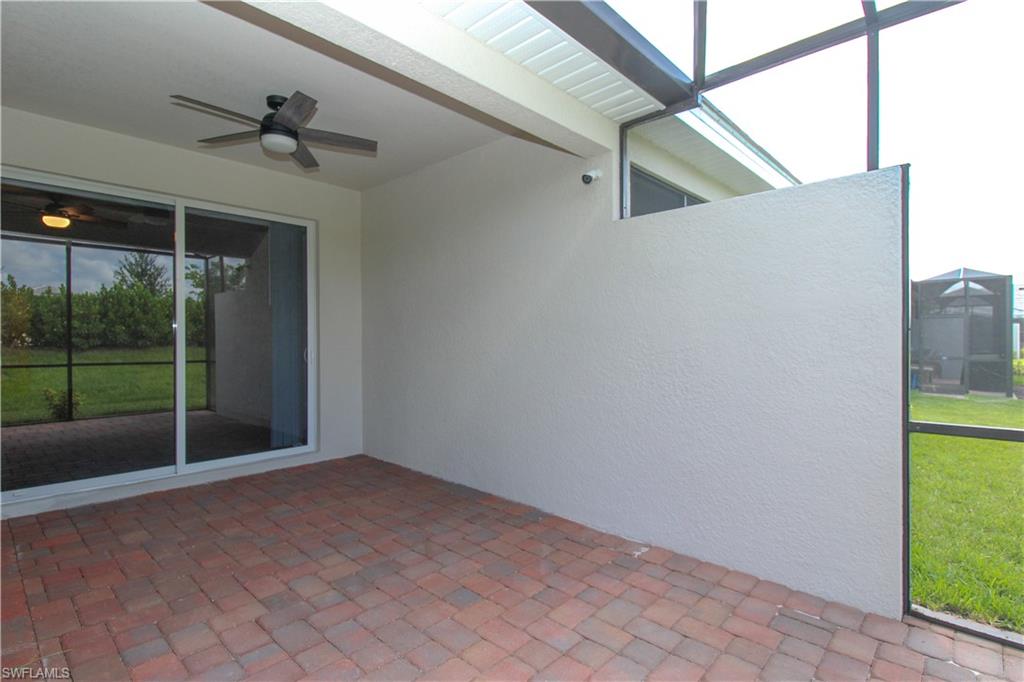2156 Dragonfruit Way Naples, FL 34120 - Photo 18 of 50 Unfurnished sunroom with ceiling fan
