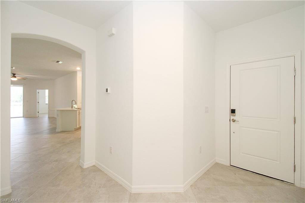2156 Dragonfruit Way Naples, FL 34120 - Photo 24 of 50 Hallway with light tile patterned floors