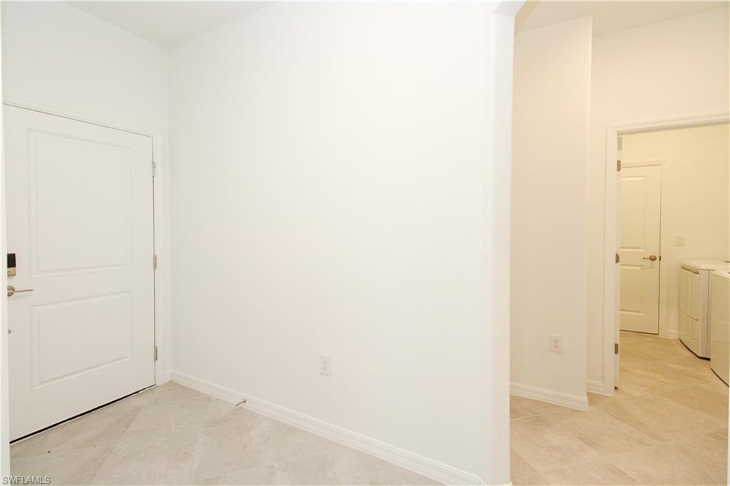 2156 Dragonfruit Way Naples, FL 34120 - Photo 25 of 50 Tiled spare room featuring washing machine and clothes dryer