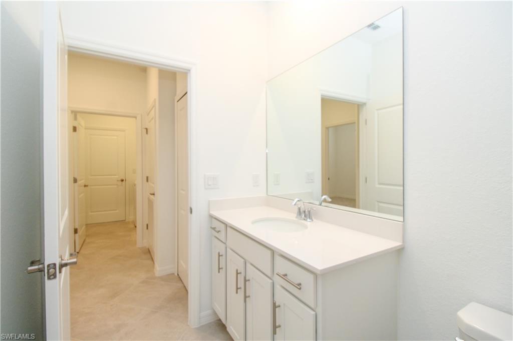 2156 Dragonfruit Way Naples, FL 34120 - Photo 31 of 50 Bathroom featuring tile patterned floors, toilet, and vanity