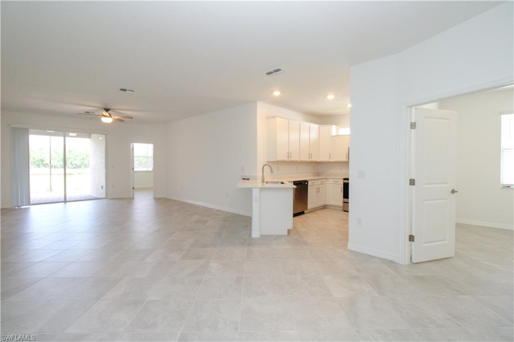 2156 Dragonfruit Way Naples, FL 34120 - Photo 33 of 50 Kitchen with dishwasher, kitchen peninsula, ceiling fan, and light tile patterned floors