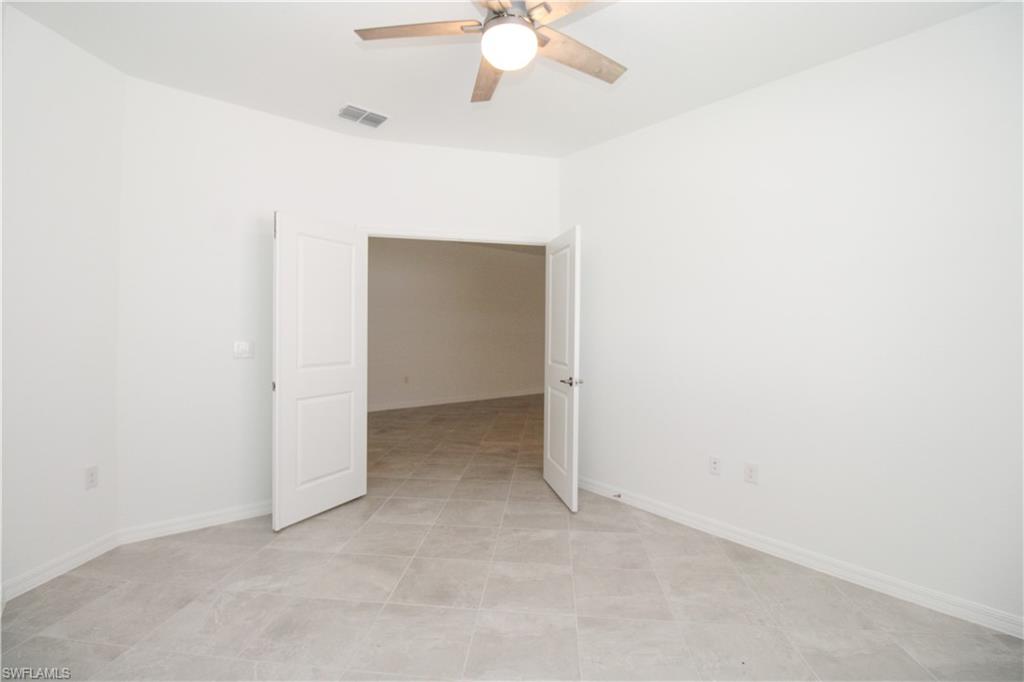 2156 Dragonfruit Way Naples, FL 34120 - Photo 41 of 50 Tiled empty room with ceiling fan