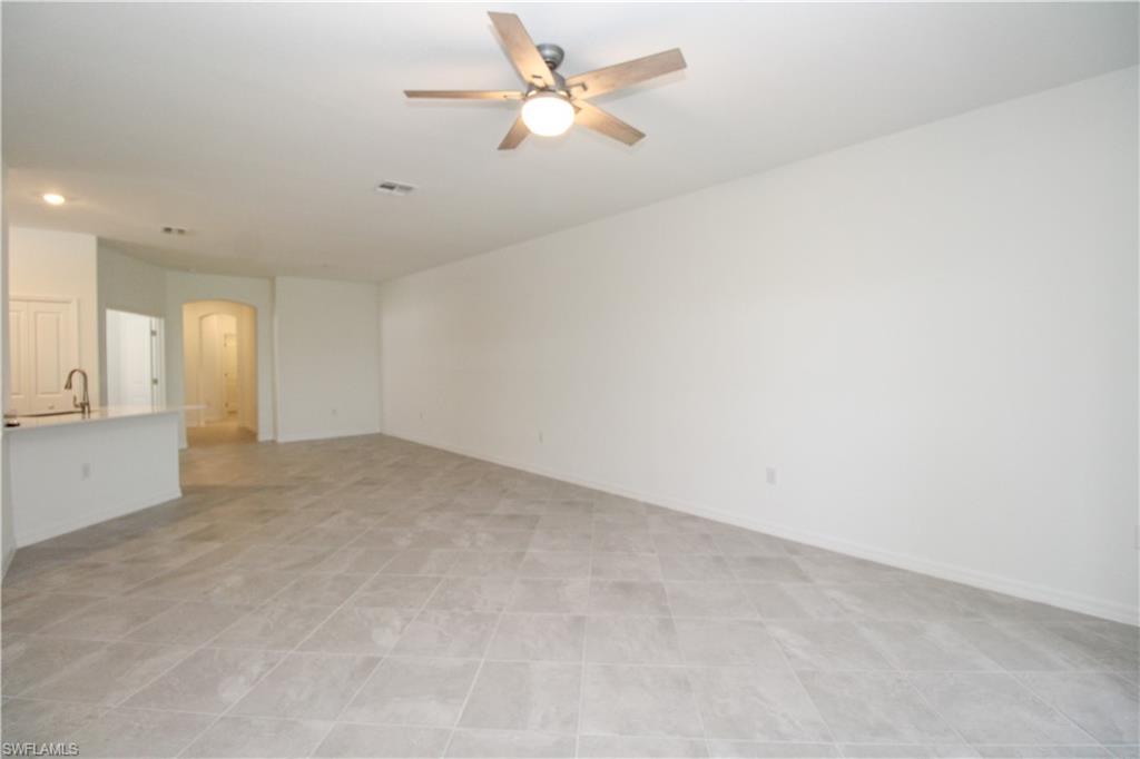 2156 Dragonfruit Way Naples, FL 34120 - Photo 43 of 50 Empty room with sink, light tile patterned floors, and ceiling fan