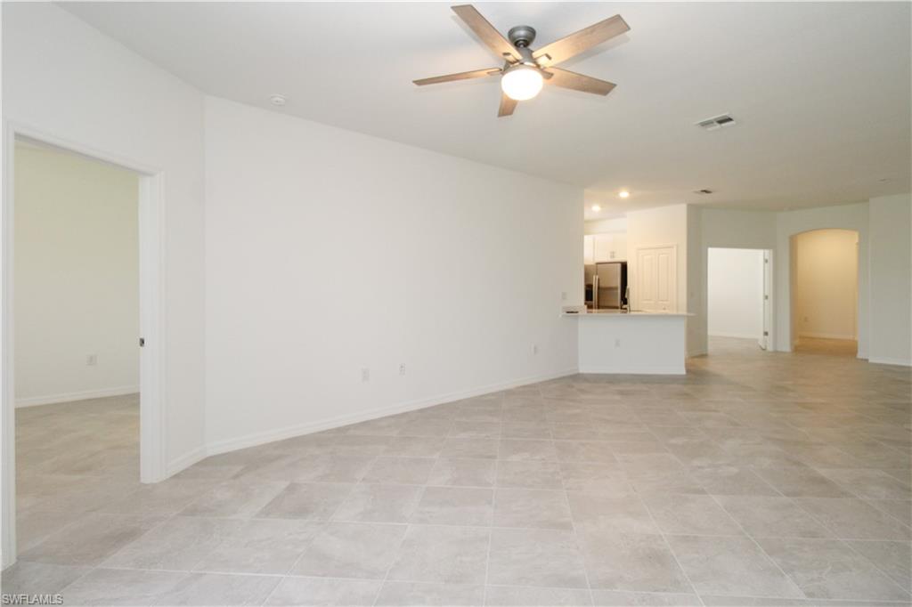 2156 Dragonfruit Way Naples, FL 34120 - Photo 45 of 50 Tiled empty room with ceiling fan