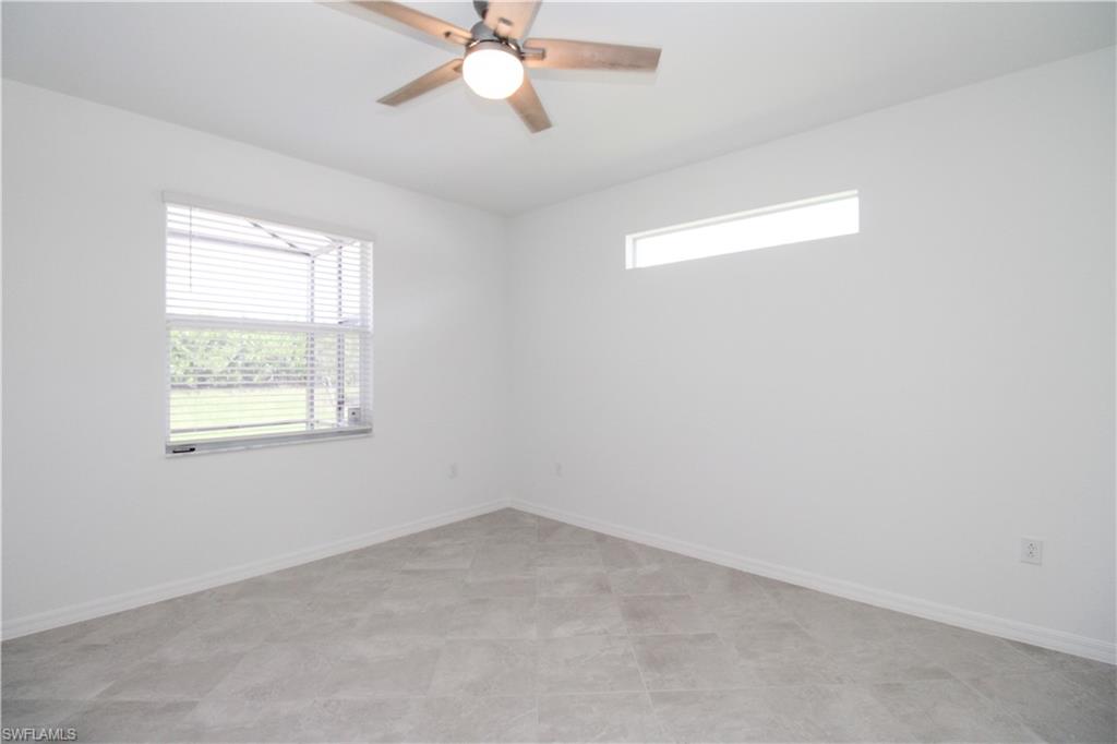 2156 Dragonfruit Way Naples, FL 34120 - Photo 46 of 50 Tiled spare room with ceiling fan and a wealth of natural light