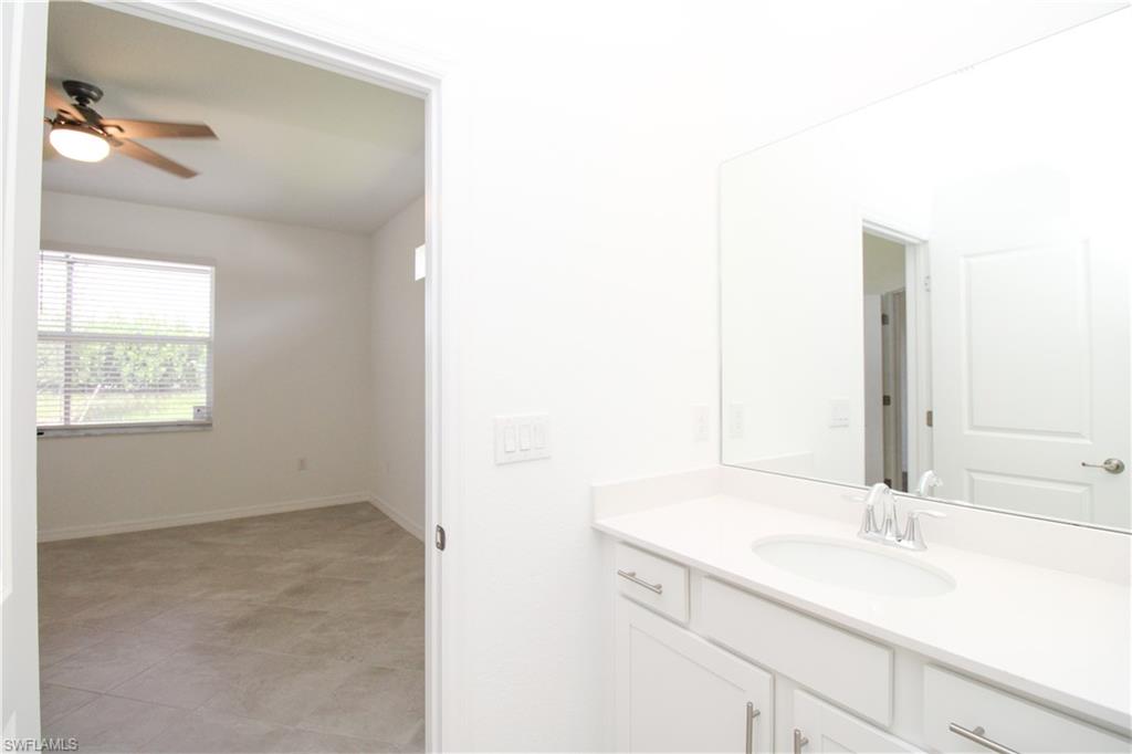 2156 Dragonfruit Way Naples, FL 34120 - Photo 50 of 50 Bathroom with vanity, tile patterned floors, and ceiling fan