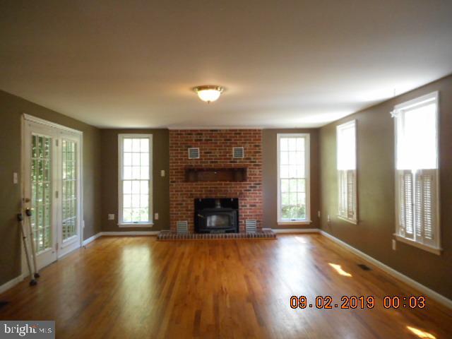1520 Old Plum Point Road Huntingtown, MD 20639 - Photo 6 of 14 a view of an empty room with window and fire place