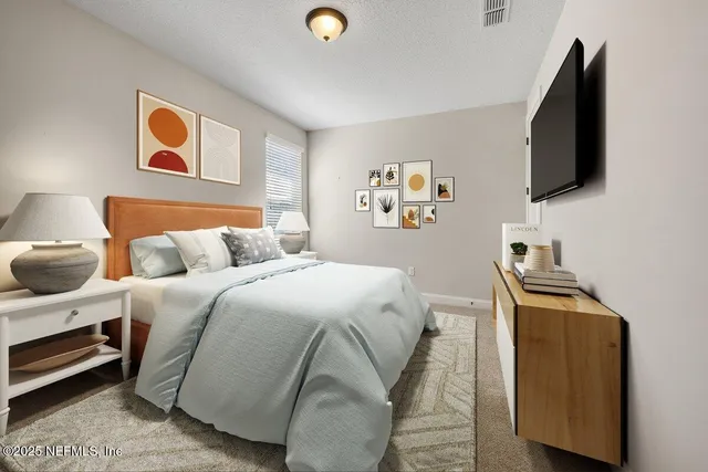 a bedroom with a bed and a flat screen tv