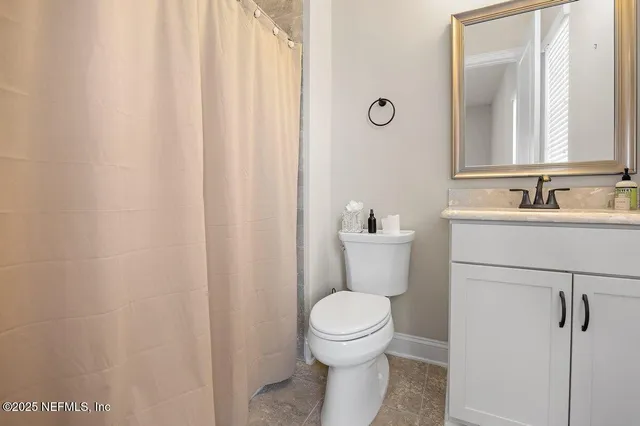 a bathroom with a toilet a sink and a mirror