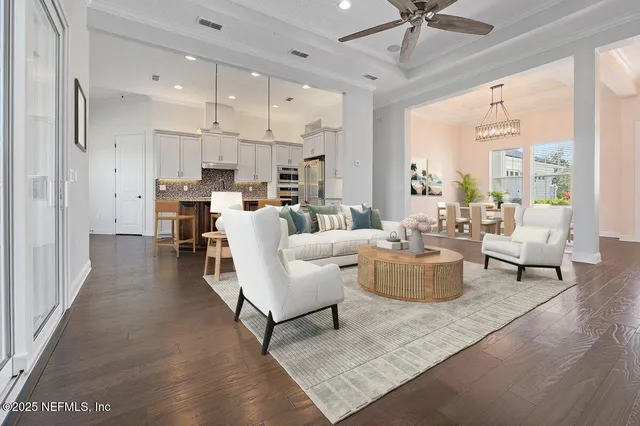 a living room with lots of furniture and kitchen view