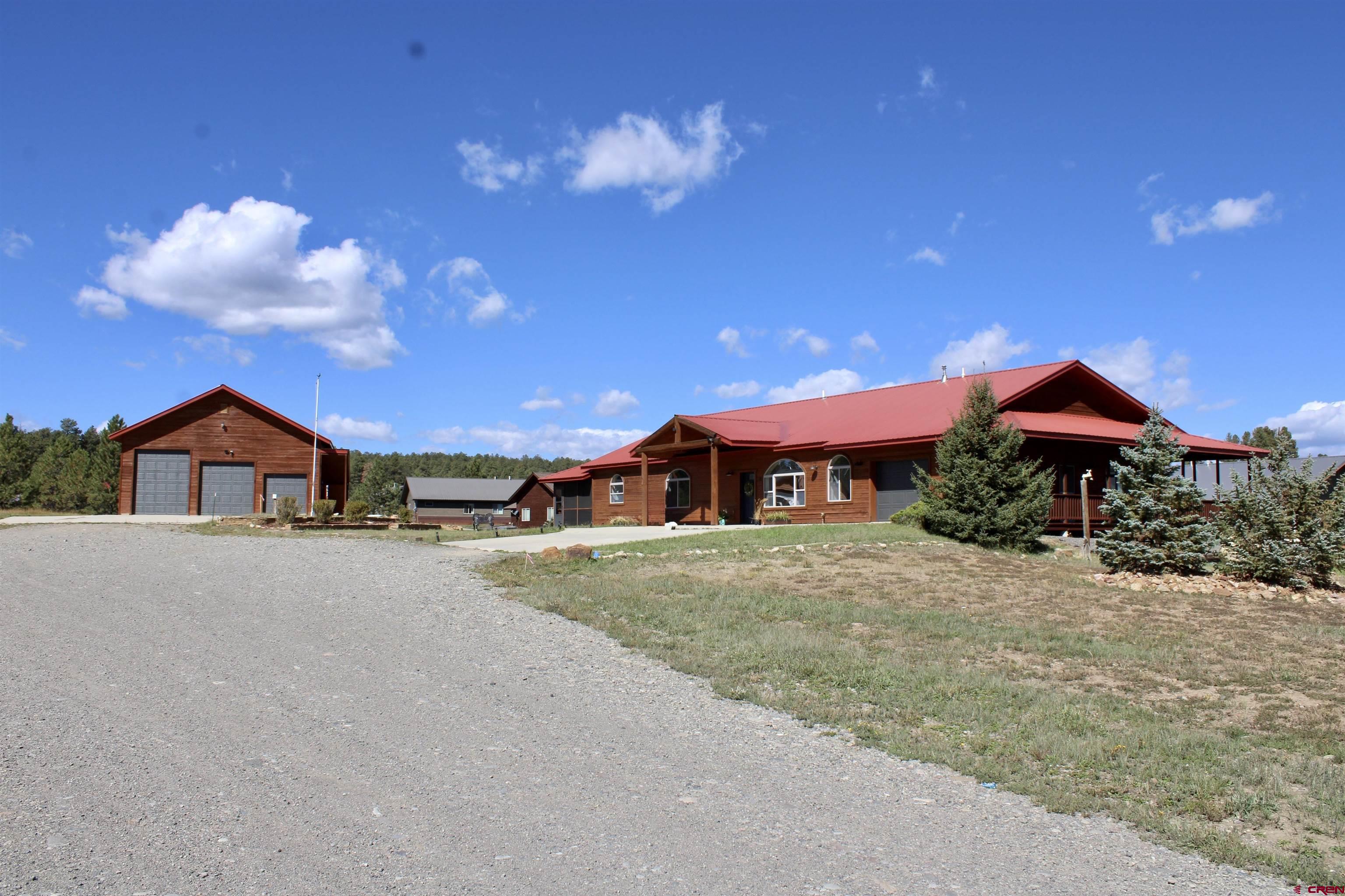 a view of a house with a yard and porch