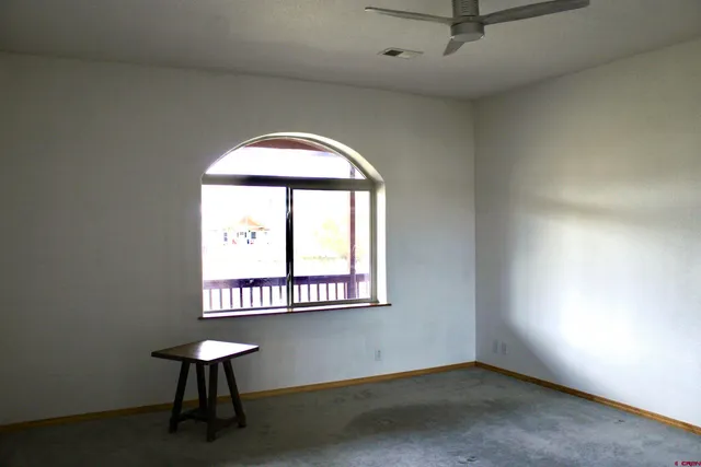 a bathroom with a mirror and a plant