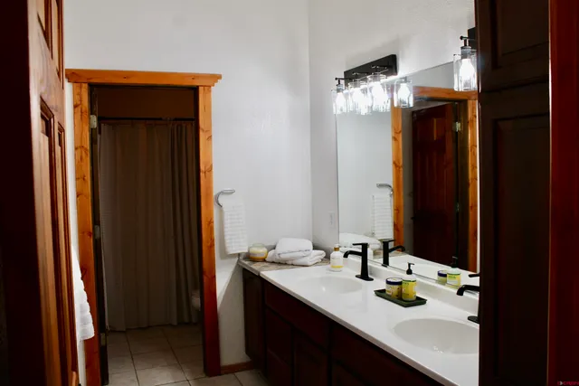 a bathroom with a shower curtain and a window