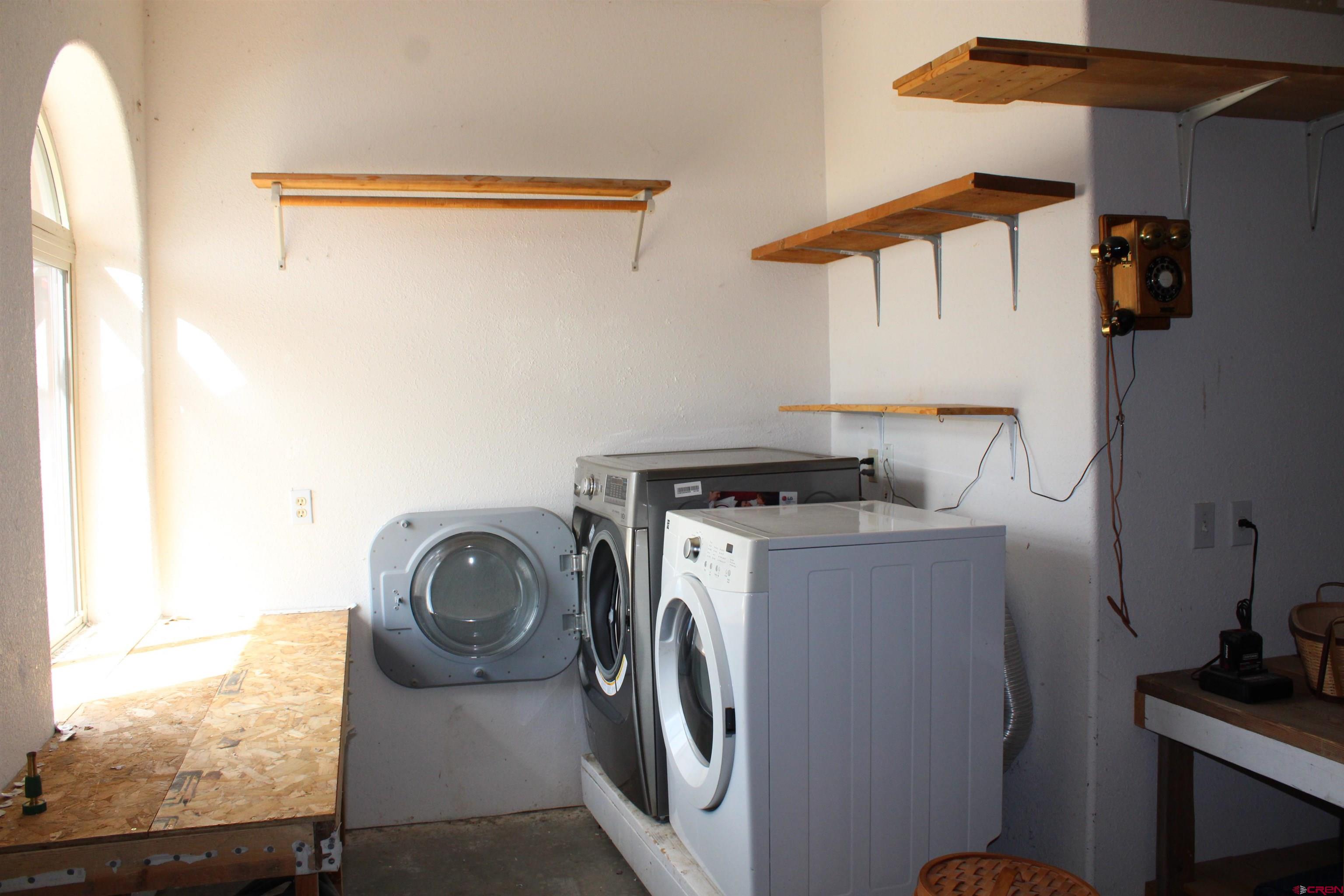 59 Rincon Court Pagosa Springs, CO 81147 - Photo 26 of 37 a utility room with dryer and washer