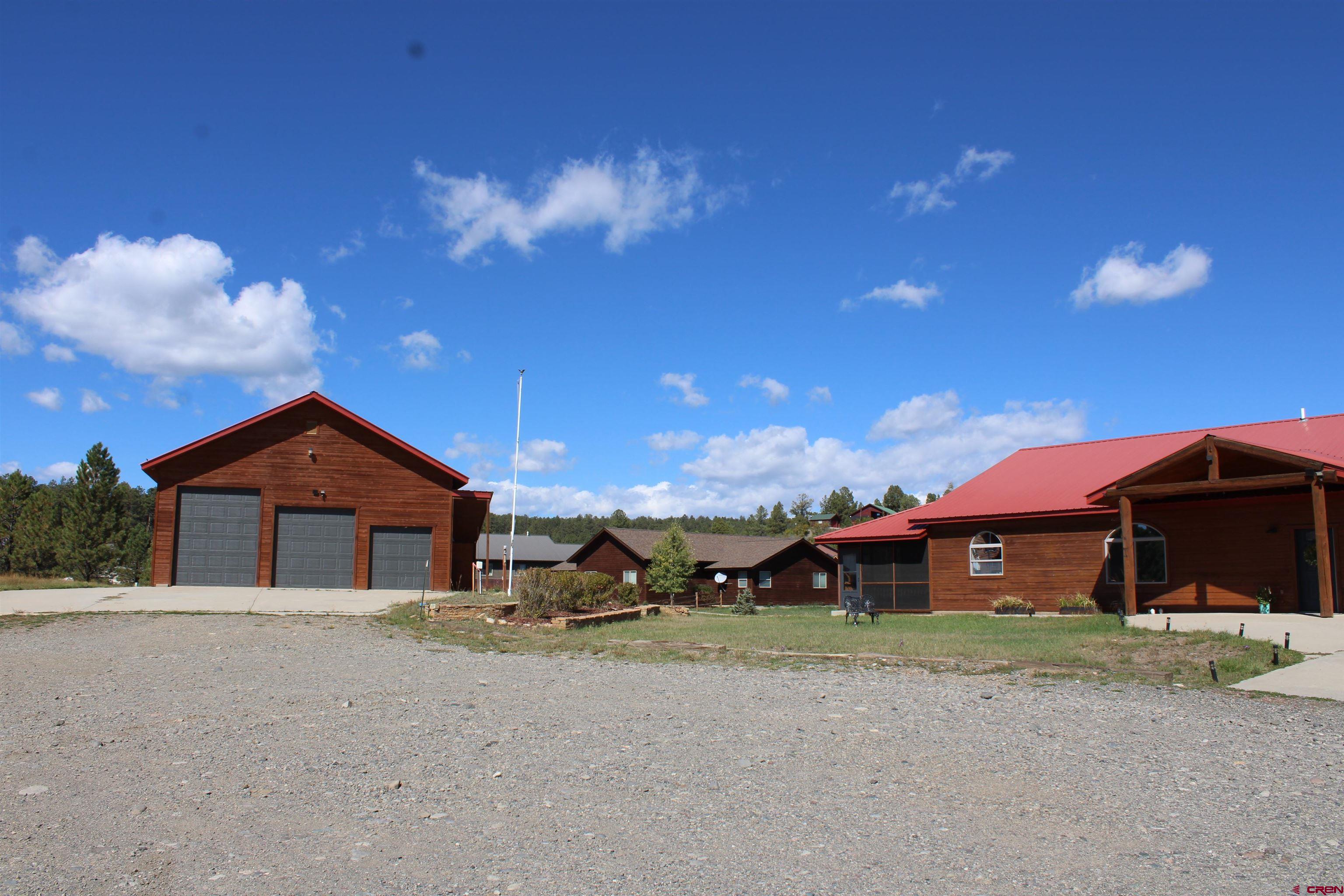 59 Rincon Court Pagosa Springs, CO 81147 - Photo 32 of 37 a front view of a house with a yard and garage