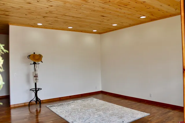 a view of a room with a sink and wooden floor