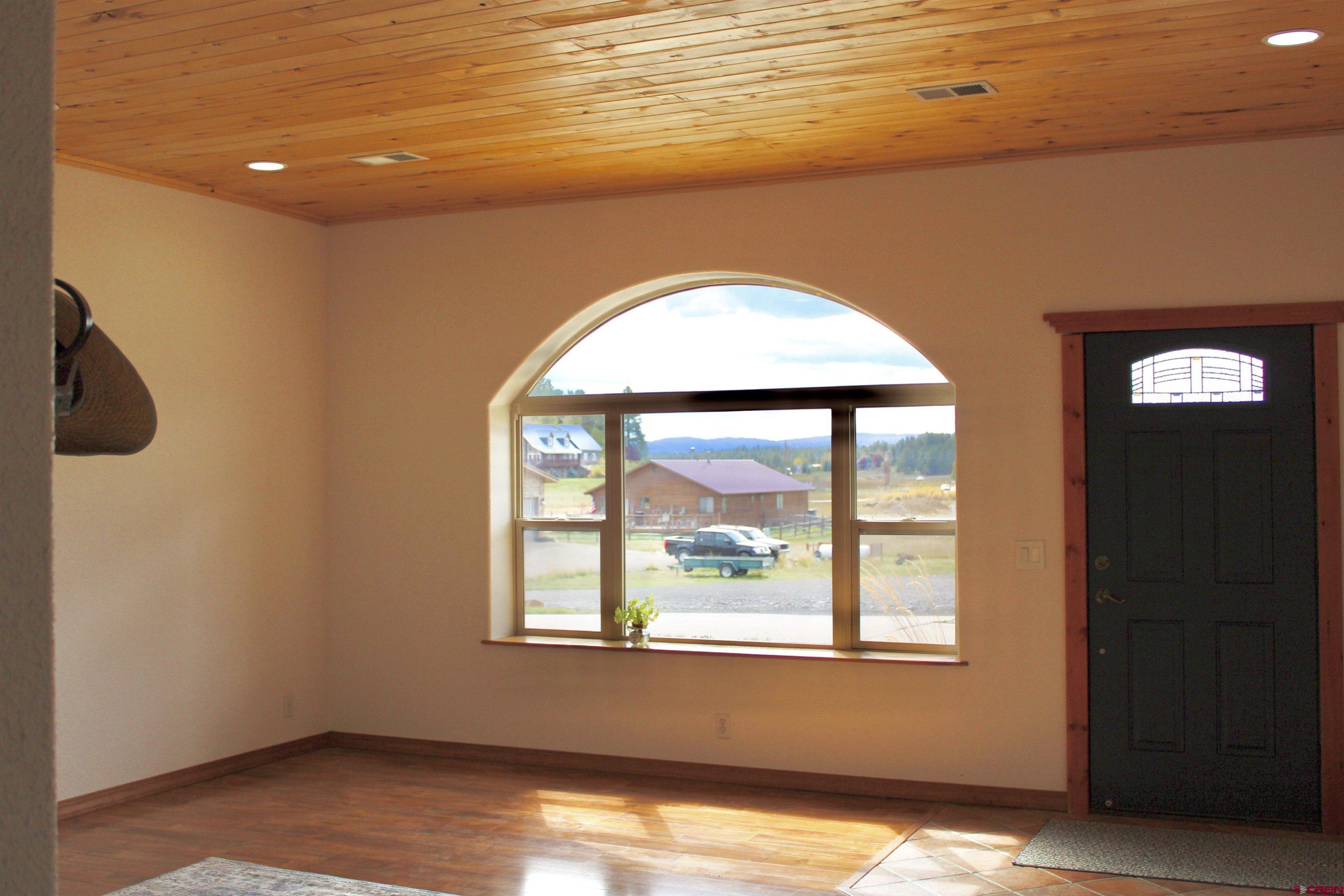 59 Rincon Court Pagosa Springs, CO 81147 - Photo 5 of 37 a view of a livingroom with wooden floor and a window