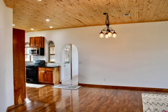 a view of a living room with fireplace furniture and wooden floor