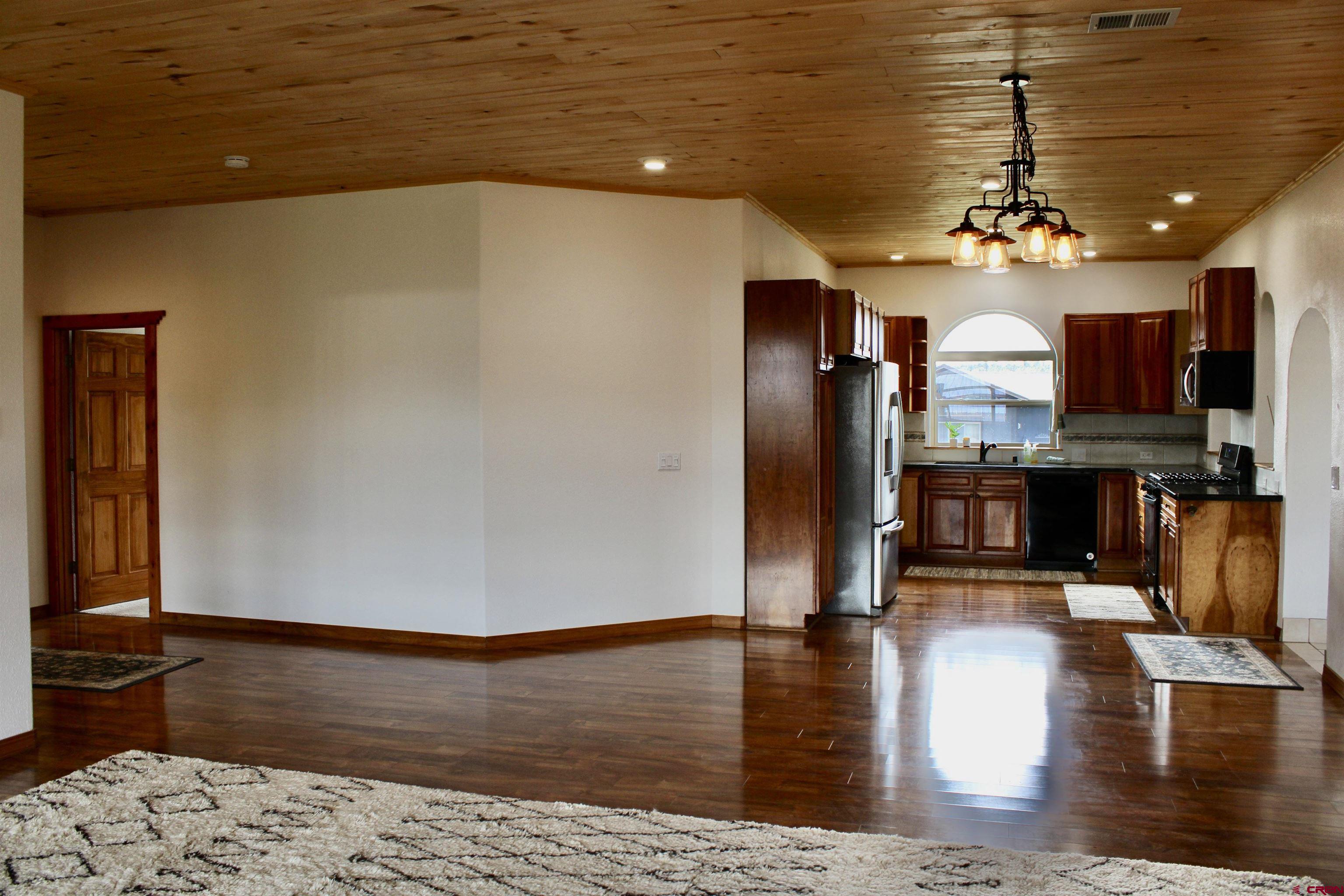 59 Rincon Court Pagosa Springs, CO 81147 - Photo 9 of 37 a view of a living room with fireplace furniture and wooden floor