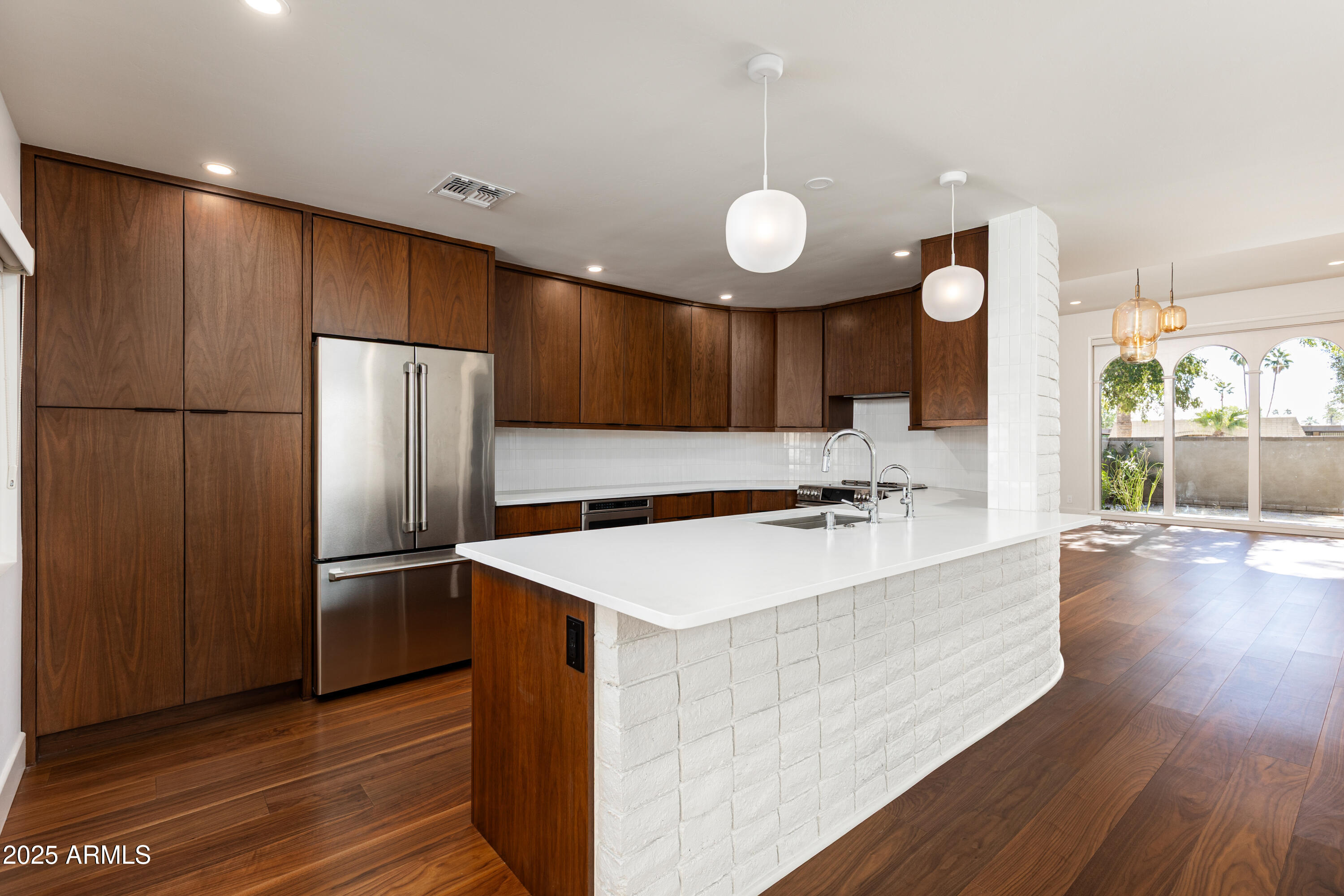 a kitchen with kitchen island a sink stove and refrigerator