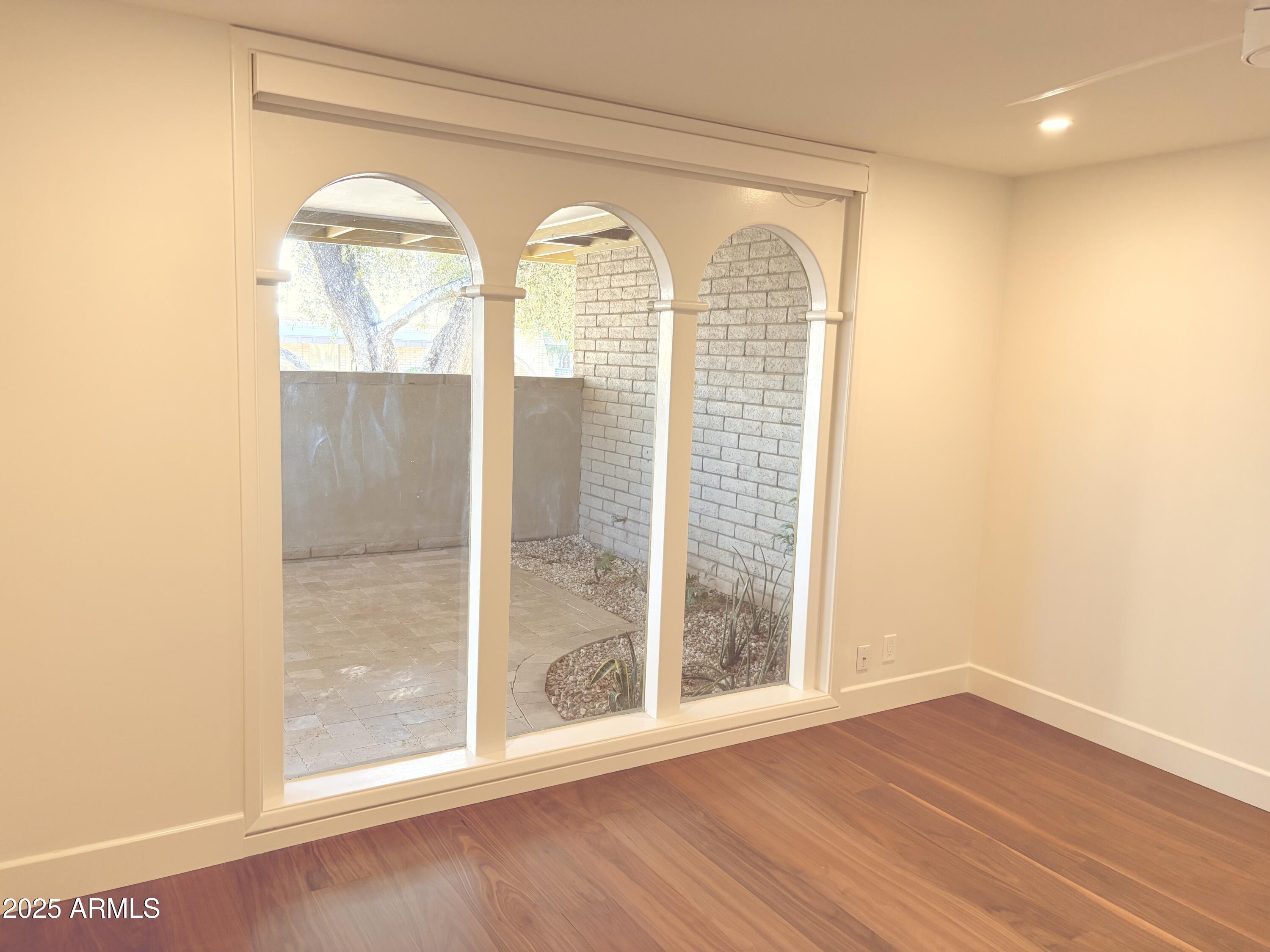 3736 East Montecito Avenue Phoenix, AZ 85018 - Photo 13 of 42 a view of empty room with wooden floor and fan