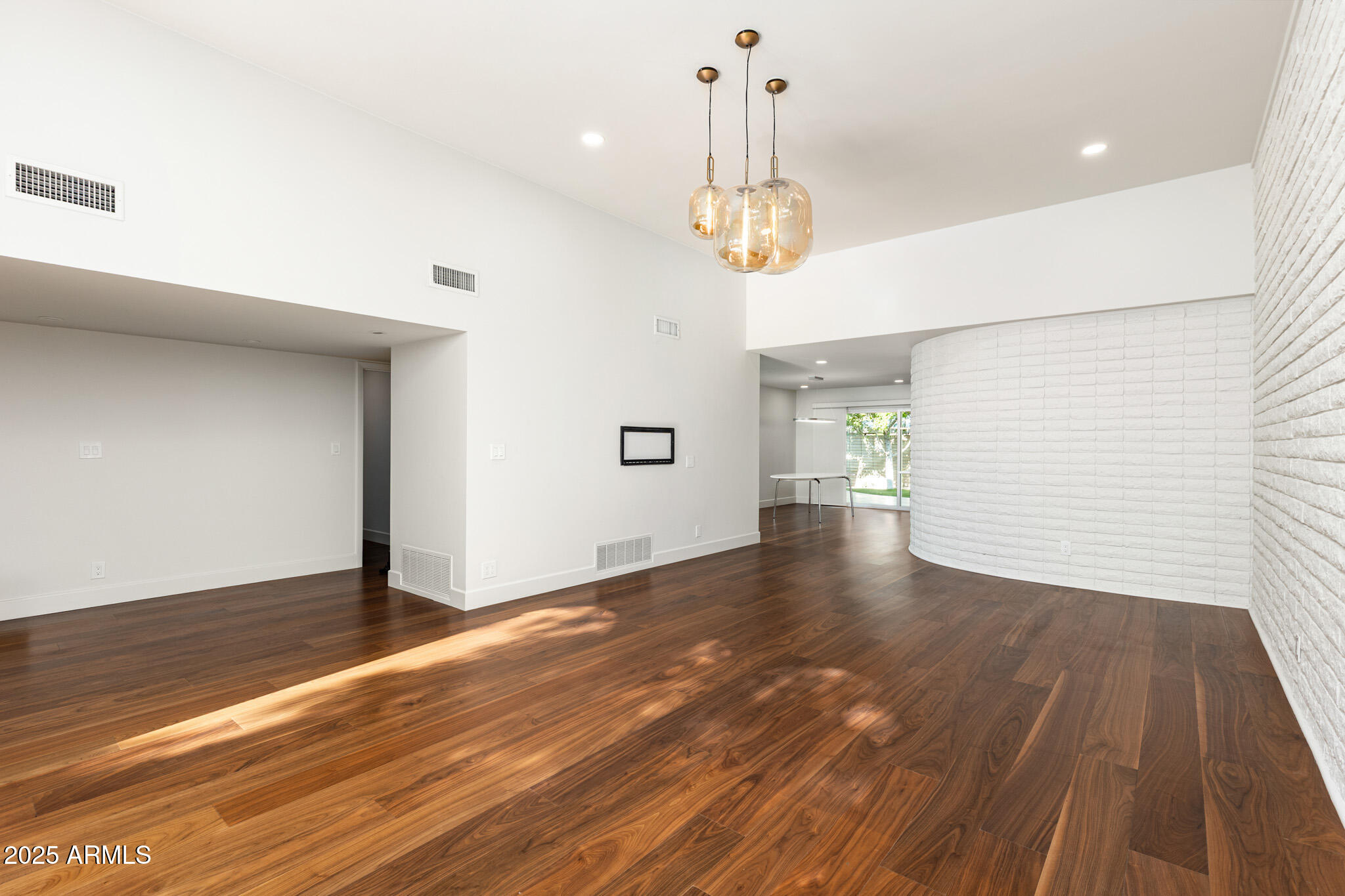 3736 East Montecito Avenue Phoenix, AZ 85018 - Photo 22 of 42 a view of a room with wooden floor and chandelier