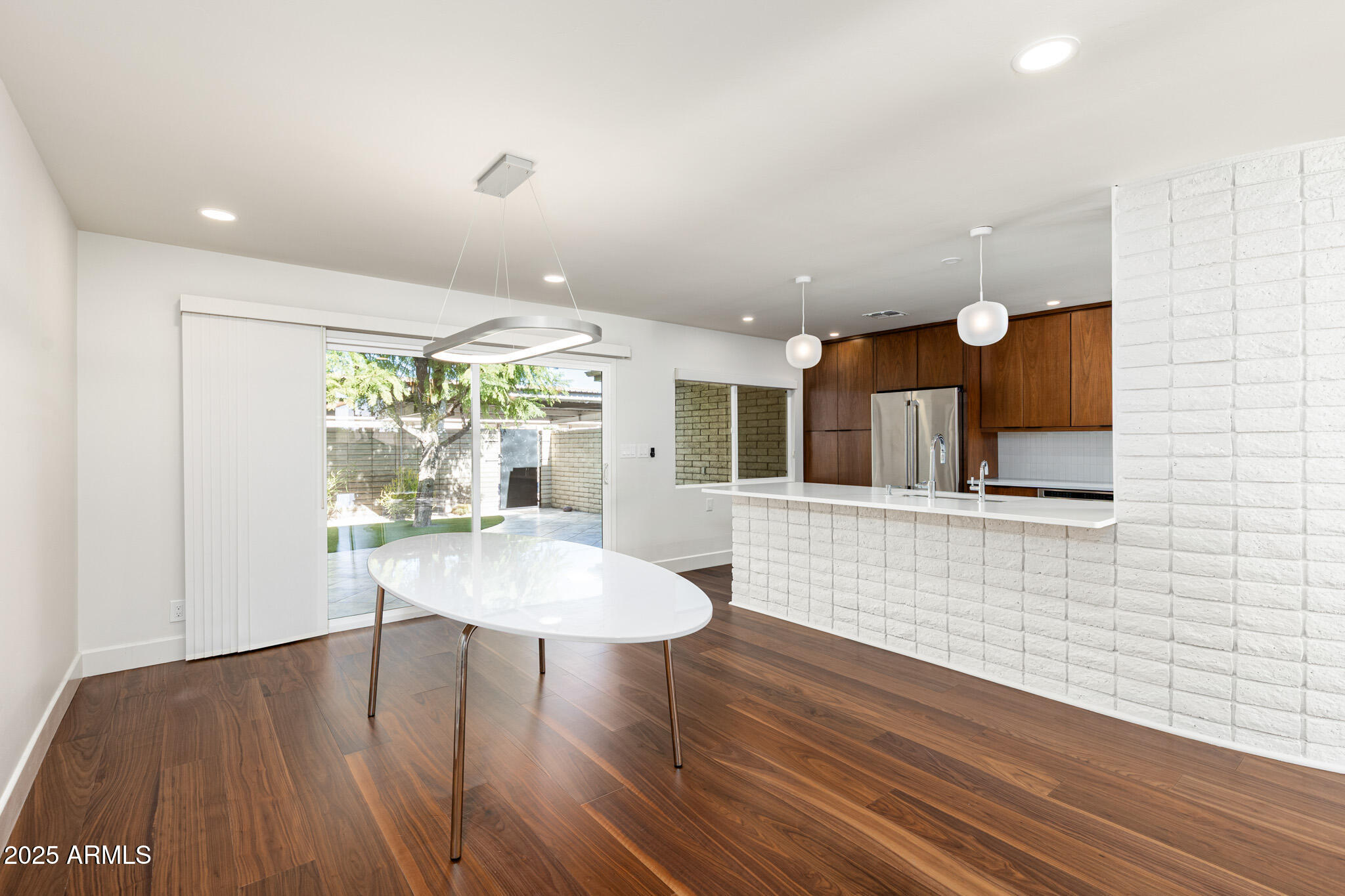3736 East Montecito Avenue Phoenix, AZ 85018 - Photo 24 of 42 a view of a dining room with furniture and wooden floor